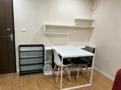 Modern minimalist dining area with sleek furniture and wooden flooring