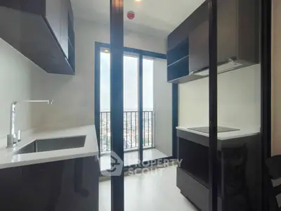 Modern kitchen with sleek design and stunning city view from balcony