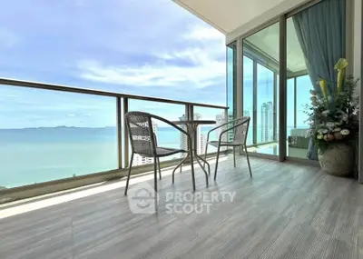 Stunning ocean view from a spacious balcony with modern seating, perfect for relaxation.