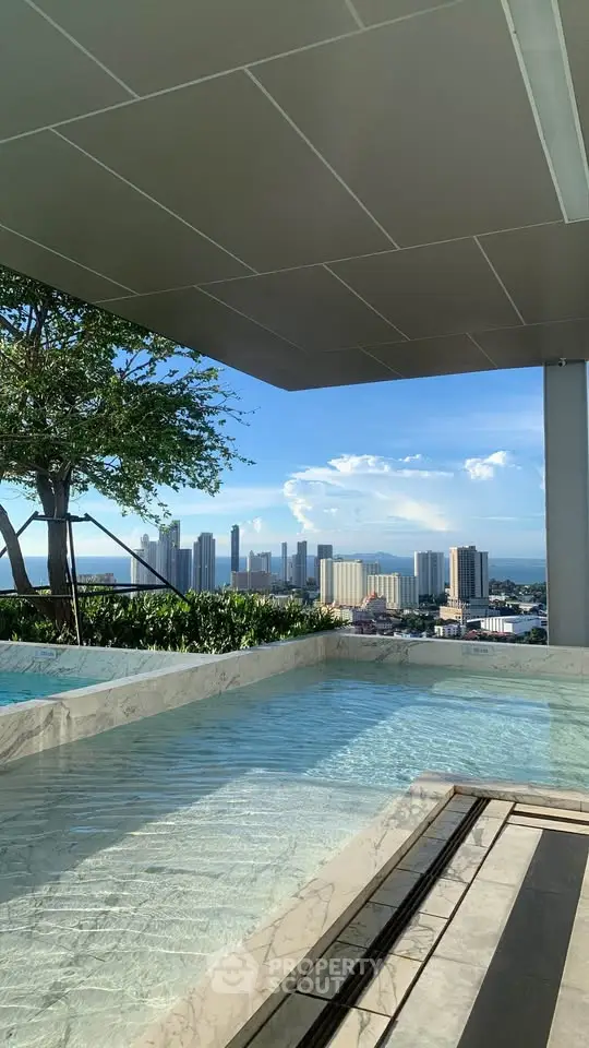Luxurious rooftop pool with stunning city skyline view, perfect for relaxation and leisure.