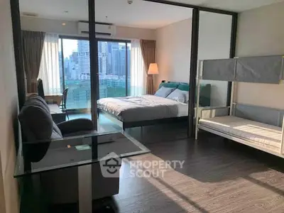 Modern bedroom with city view, featuring a cozy bed and stylish decor.