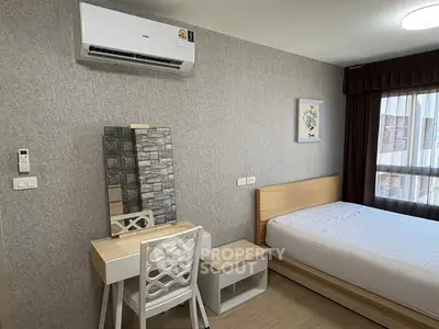Modern bedroom with air conditioning and stylish decor in a cozy apartment.