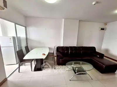 Modern living room with sleek furniture and dining area in open layout