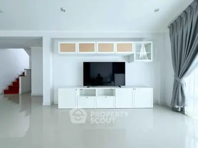 Spacious modern living room with sleek TV unit and natural light