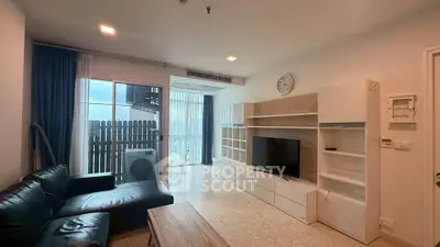 Spacious living room with modern furniture and large windows offering natural light.