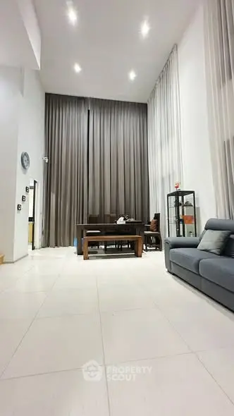 Spacious modern living room with high ceilings and elegant decor