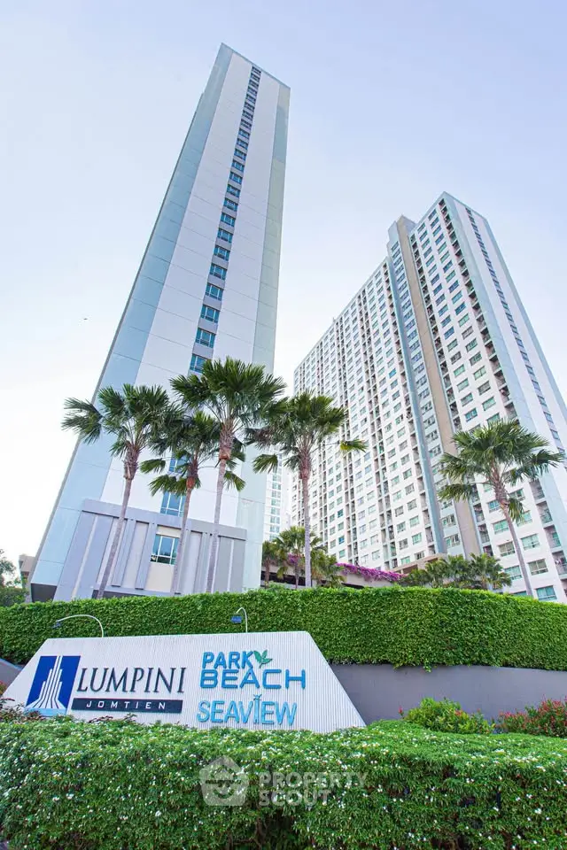 Stunning high-rise condominium with lush greenery and modern architecture in Jomtien, offering breathtaking sea views.