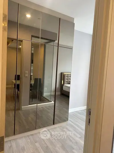 Modern bedroom with mirrored wardrobe and stylish decor