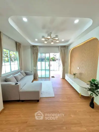 Modern living room with elegant decor and large windows for natural light