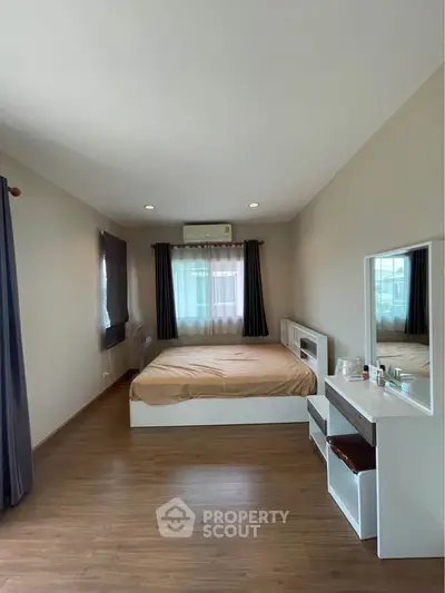 Spacious bedroom with modern decor and natural light