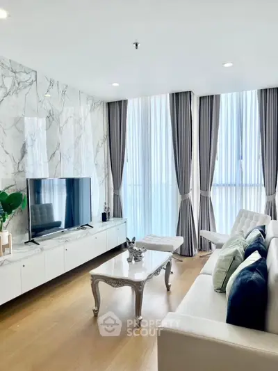 Luxurious modern living room with marble accent wall and elegant decor