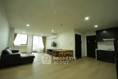 Spacious modern living room with open kitchen and natural light