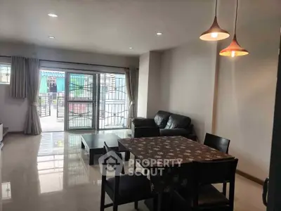 Spacious living room with modern furniture and large windows for natural light.