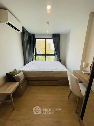 Modern bedroom with large window and stylish furniture in urban apartment