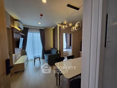 Modern living room with stylish lighting and open layout, perfect for urban living.