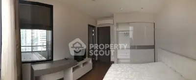 Modern bedroom with balcony view and sleek furniture