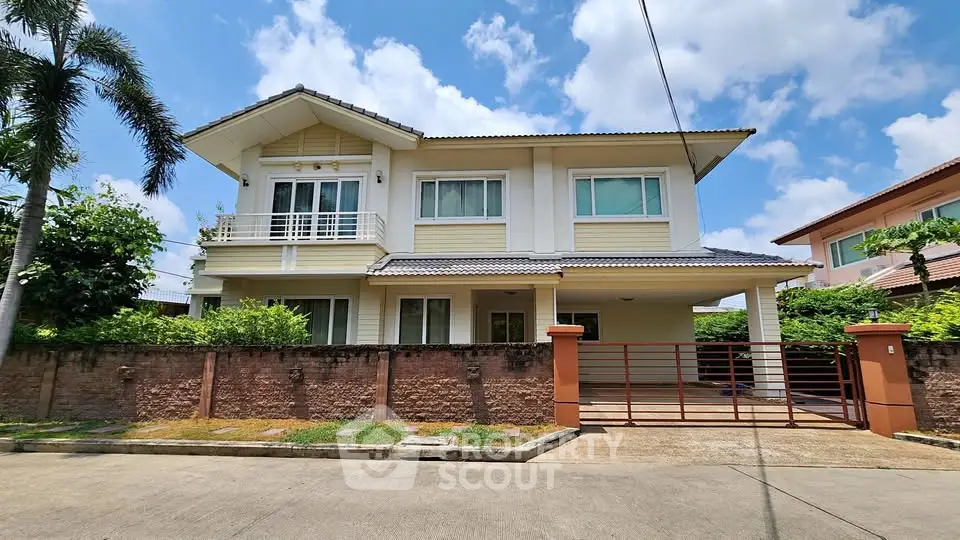 Charming two-story house with spacious driveway and lush greenery, perfect for family living.