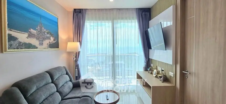 Stylish living room with ocean view and modern decor in luxury apartment.