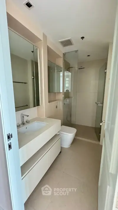 Modern bathroom with sleek fixtures and glass shower enclosure