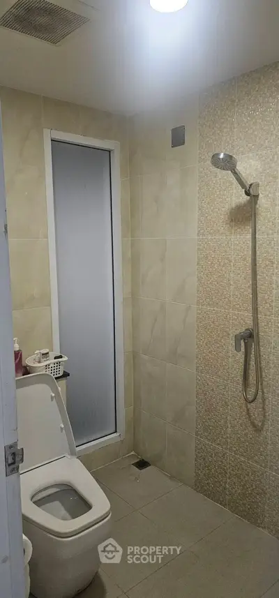 Modern bathroom with shower and toilet in neutral tones