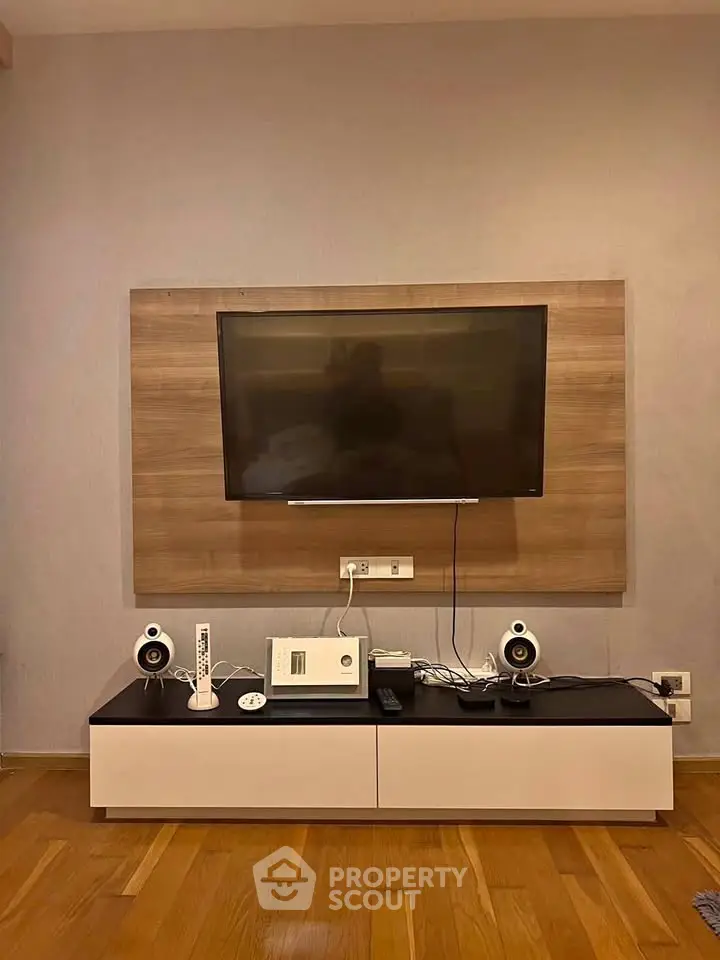 Modern living room with mounted TV and sleek entertainment unit