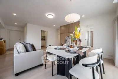 Modern open-plan living and dining area with elegant decor and ample natural light.