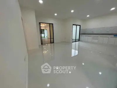 Spacious modern living room with sleek kitchen and glossy floors