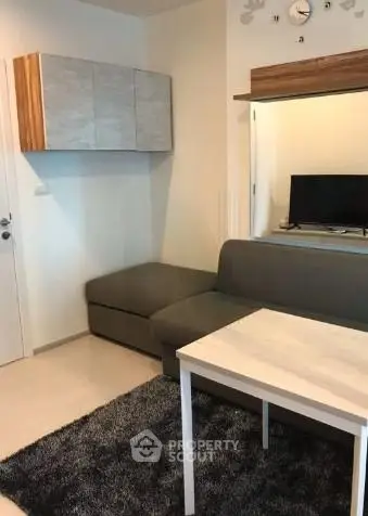 Modern living room with sleek furniture and stylish decor in a cozy apartment setting.