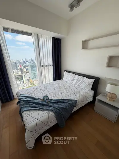 Modern bedroom with stunning city view and cozy decor