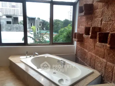 Luxurious bathroom with a spacious bathtub and scenic city view, perfect for relaxation.