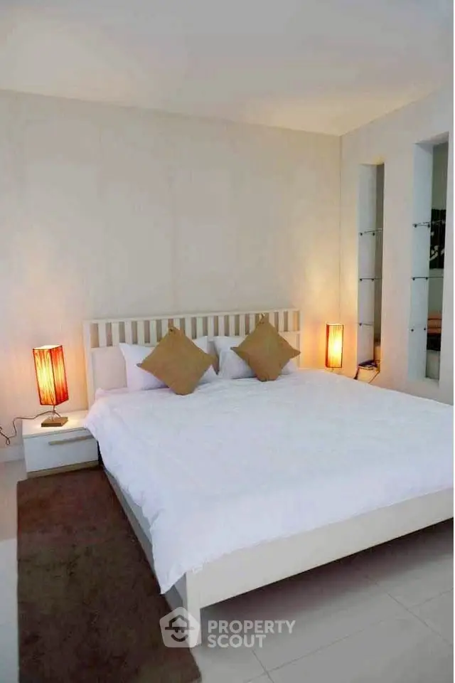 Cozy and minimalist bedroom with modern lighting and neutral tones.