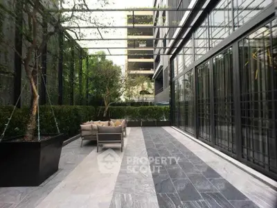 Luxurious outdoor seating area with modern design and lush greenery