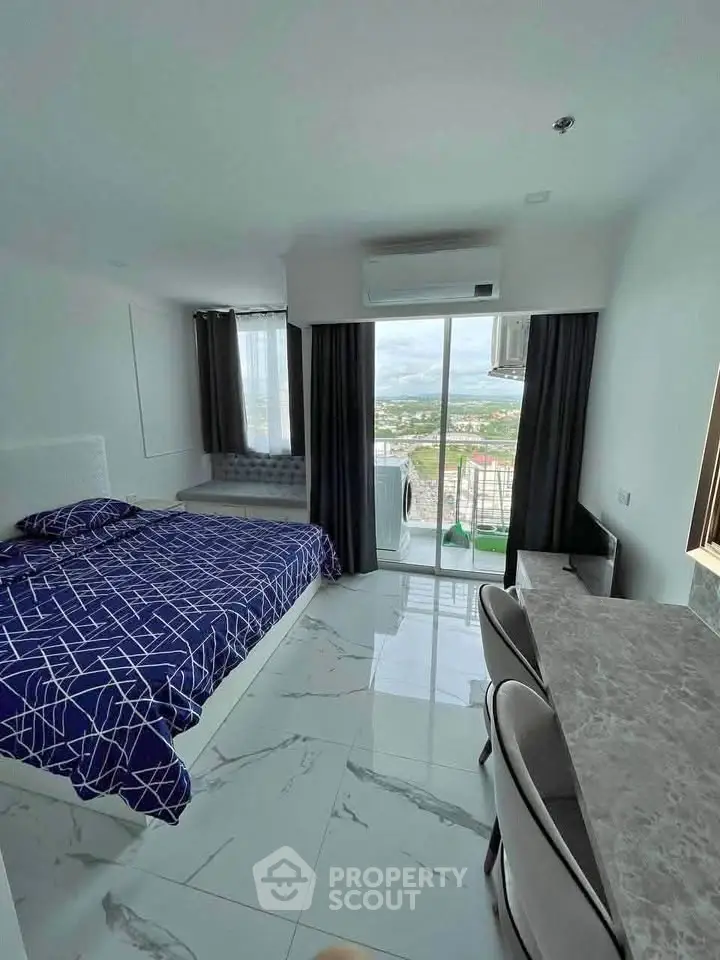 Modern bedroom with stunning view and sleek marble flooring in high-rise apartment.