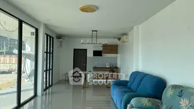 Spacious living room with modern kitchen and large windows