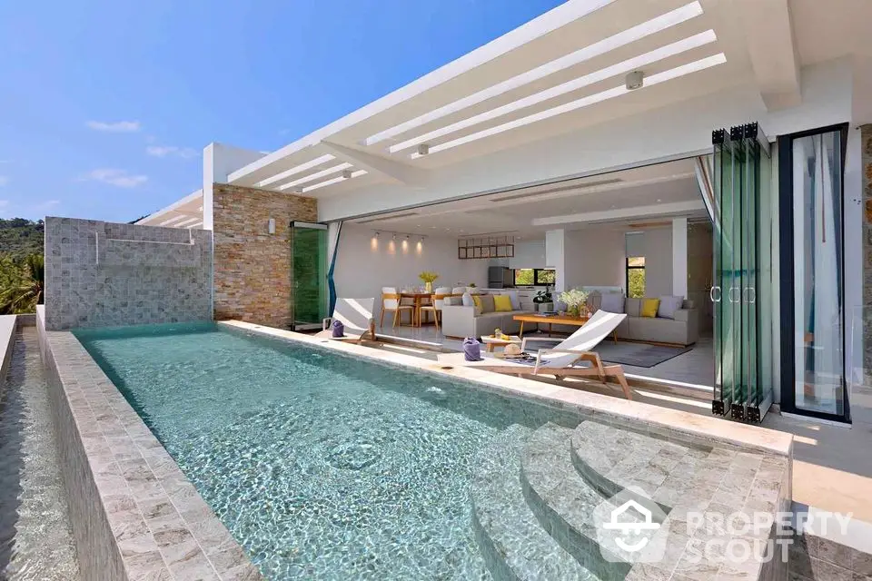 Luxurious modern villa with infinity pool and open living space, perfect for relaxation and entertainment.