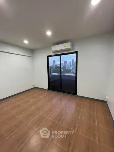 Spacious room with city view and large windows in modern apartment