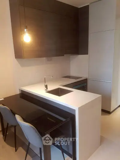 Modern kitchen with sleek design and breakfast bar seating