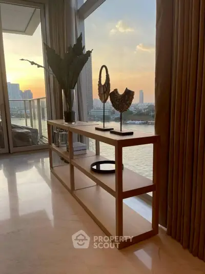 Stunning waterfront view from a modern living room with elegant decor and large windows.