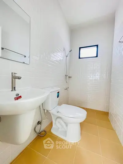 Modern bathroom with white tiles and compact design
