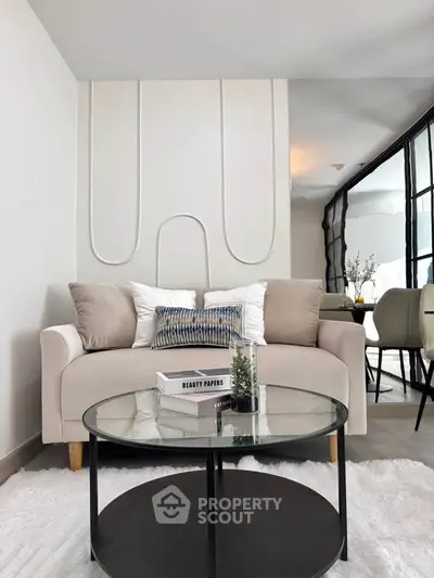 Modern living room with stylish sofa and glass coffee table, perfect for contemporary homes.