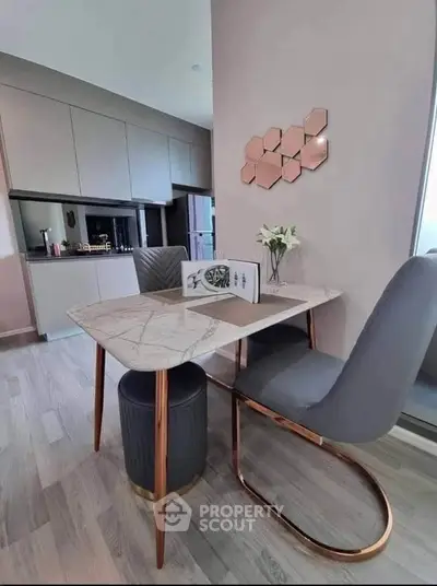 Modern dining area with elegant marble table and stylish chairs in a contemporary kitchen setting.
