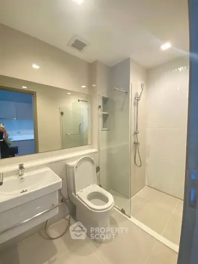 Modern bathroom with sleek fixtures and glass shower enclosure