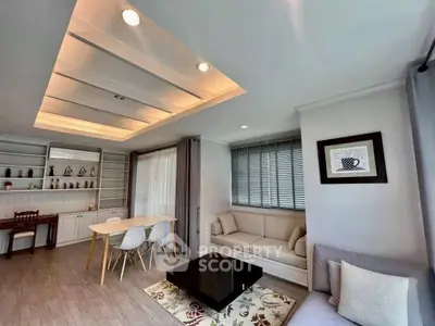 Spacious modern living room with elegant ceiling lights and cozy seating area.