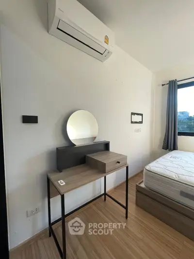Modern bedroom with sleek furniture and air conditioning, perfect for comfortable living.