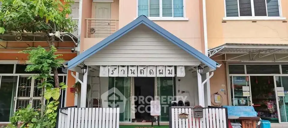 Charming townhouse with a welcoming entrance and modern facade, perfect for urban living.