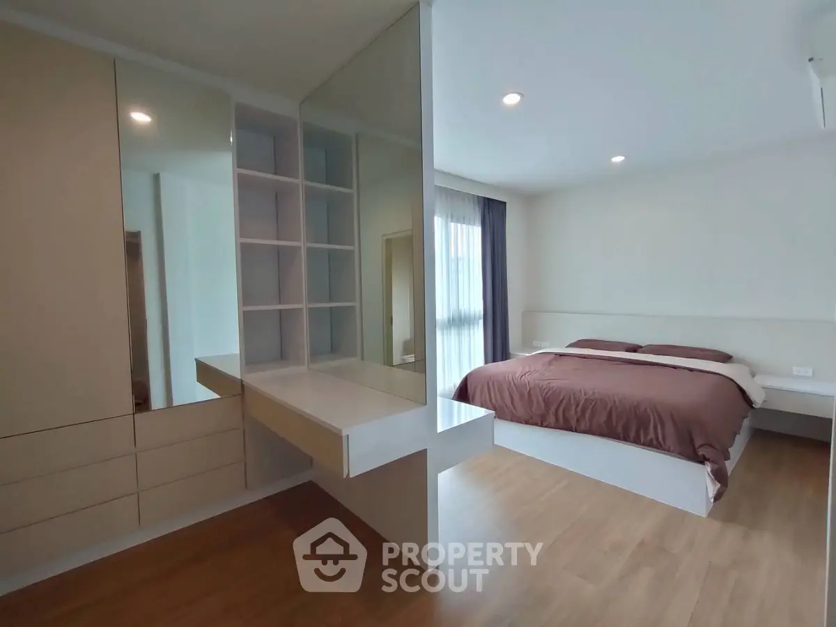 Modern bedroom with built-in storage and stylish decor