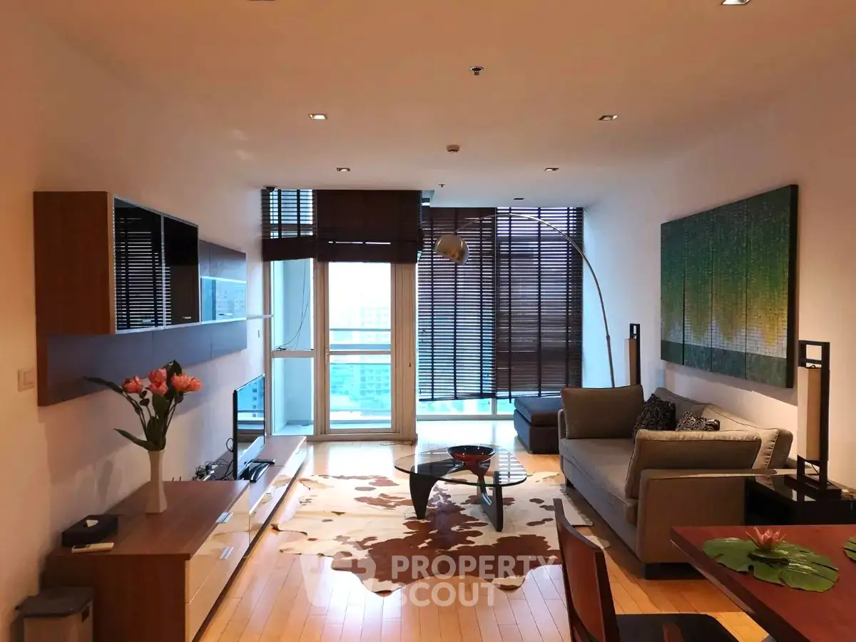 Spacious modern living room with stylish decor and large windows offering natural light.
