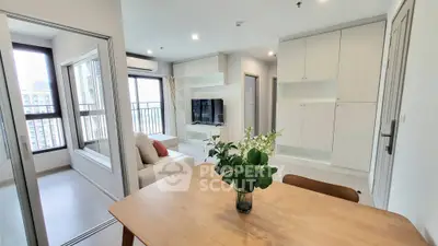 Modern living room with open layout and natural light in a stylish apartment.