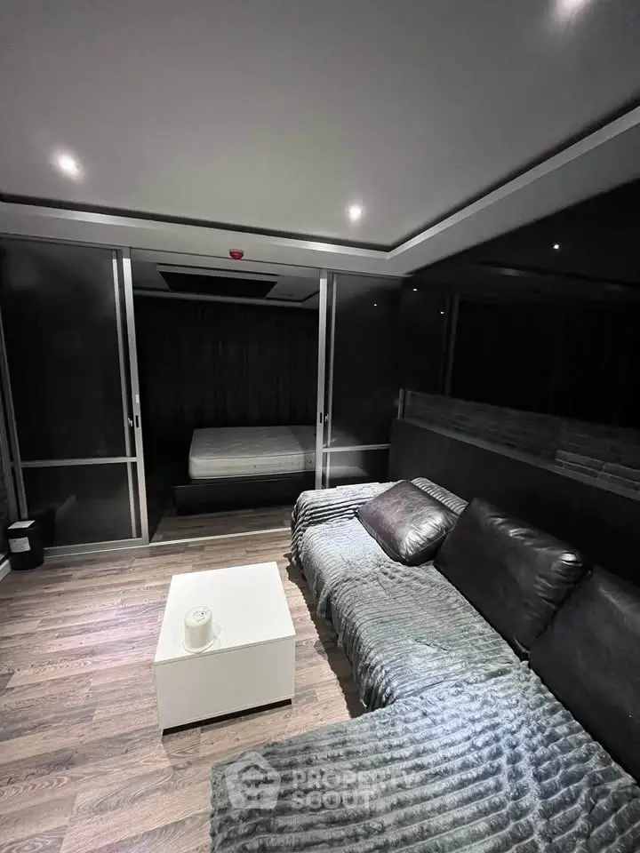 Modern living room with sleek design and cozy ambiance, featuring a stylish sofa and elegant decor.