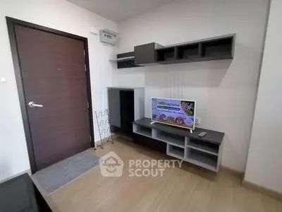 Modern living room with sleek wooden flooring and stylish TV unit